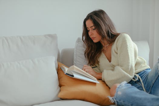 A person reading a book in a cozy setting